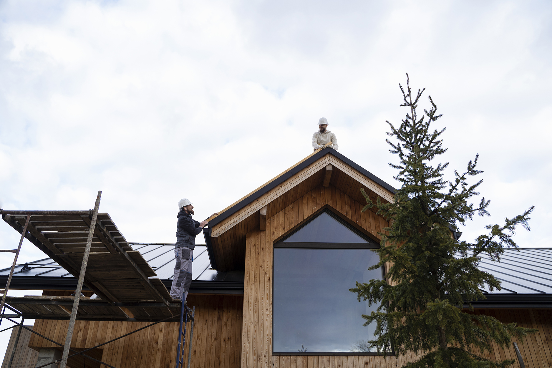 long-shot-men-working-together-roof